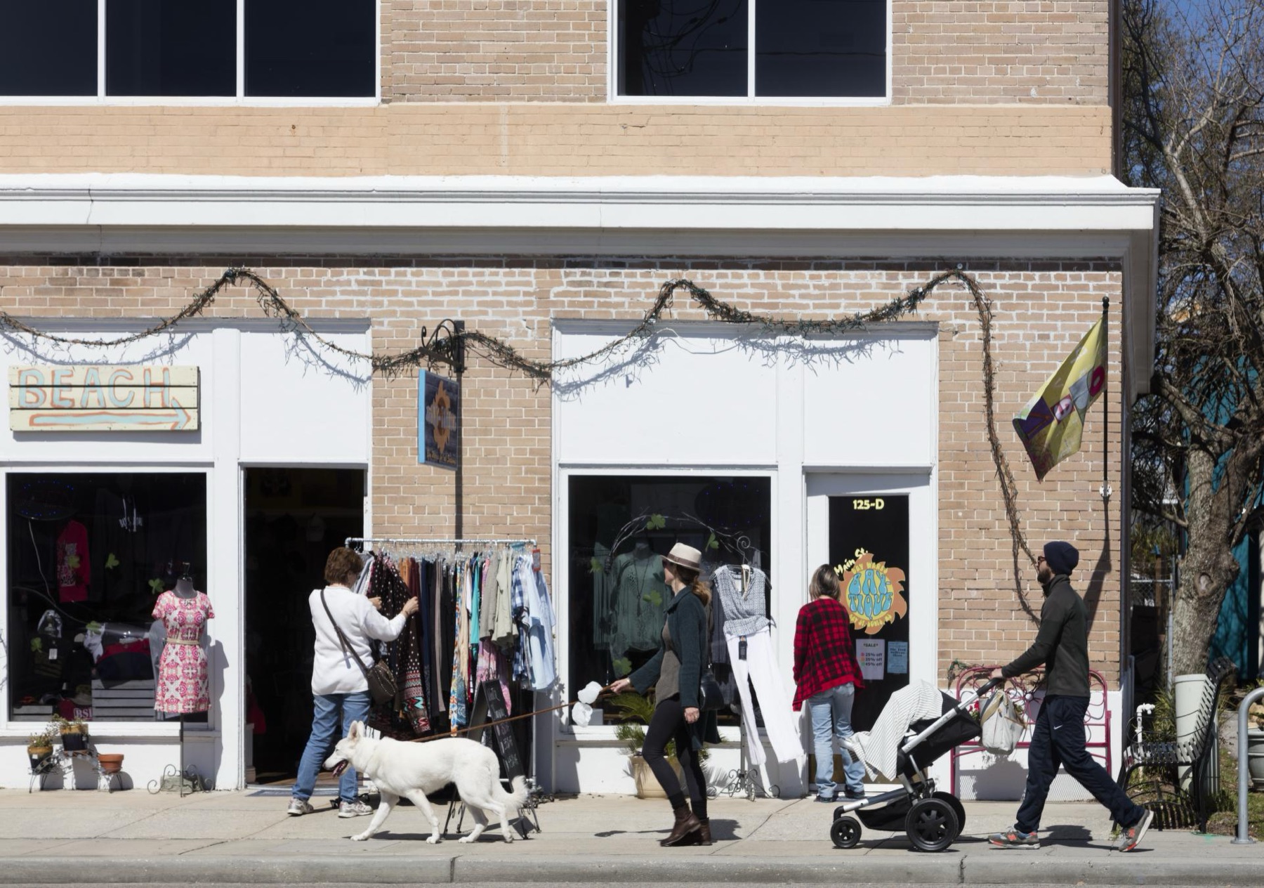 People walking past brick storefronts in Bay St. Louis in 2016