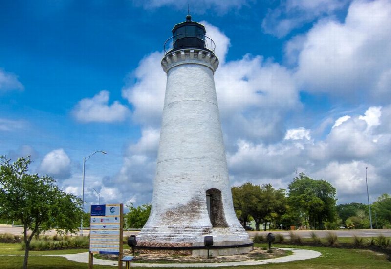 The restored Round Island Lighthouse beneath a blue sky in Pascagoula.